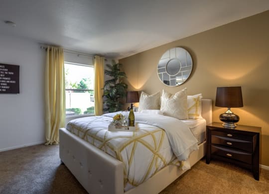 a bedroom with a large bed and a window at Bella Terra Apartments, Henderson