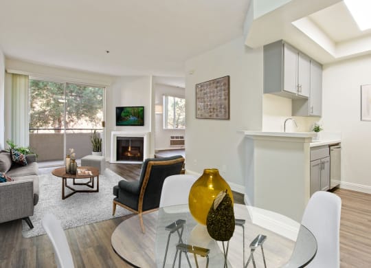 a living room with a glass table and chairs at Palm Royale Apartments, California, 90034