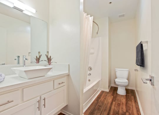 a bathroom with white cabinets at Palm Royale Apartments, California, 90034