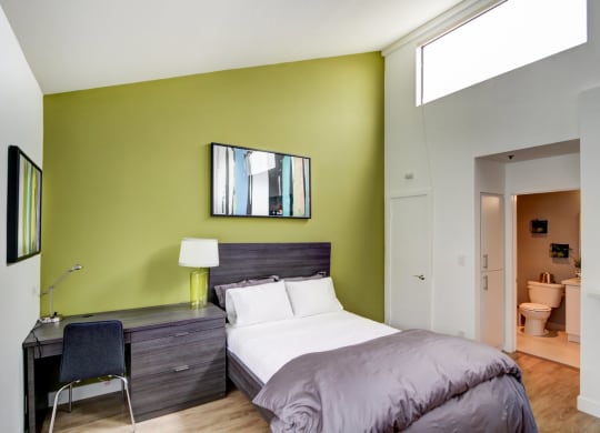 a bedroom with a bed and a desk  at El Greco Lofts, Los Angeles, 90024