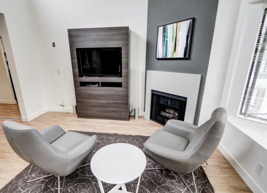a living room with a fireplace and two couches  at El Greco Lofts, Los Angeles, California