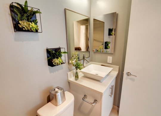 a bathroom with a sink and a mirror  at El Greco Lofts, Los Angeles