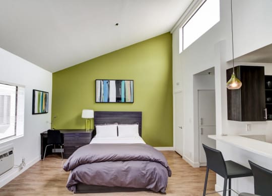 a bedroom with a bed and a desk in a room  at El Greco Lofts, California