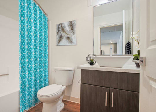 a bathroom with a toilet sink and a shower at Atrium, Los Angeles