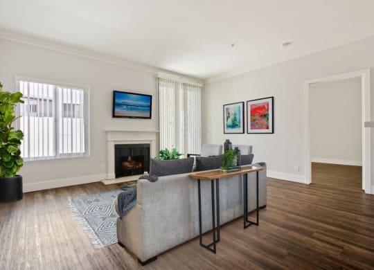 a living room with a couch and a fireplace at Atrium, Los Angeles, CA