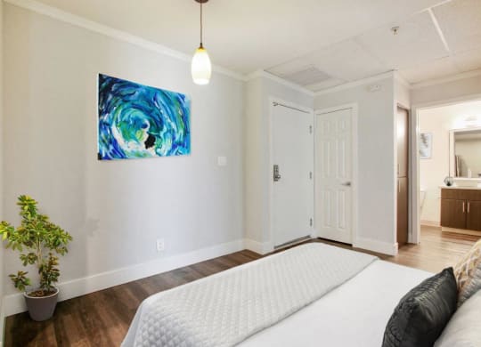 a bedroom with a bed and a painting on the wall at Atrium, Los Angeles, 90024