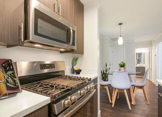 a kitchen and dining room with a stove and a microwave at Atrium, Los Angeles, CA