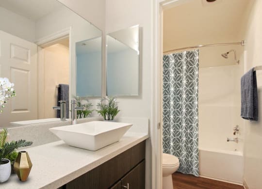 a bathroom with a sink and a shower and a mirror at Atrium, Los Angeles, CA, 90024