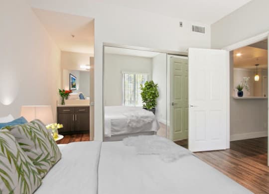 a bedroom and a bathroom with a bed and a mirror at Atrium, Los Angeles, CA