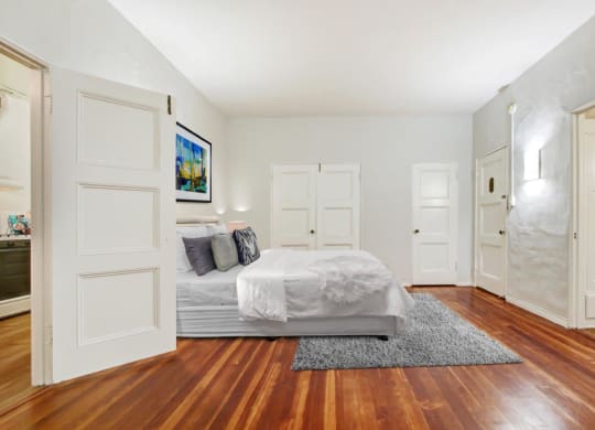 a bedroom with a bed and a door that leads to a bathroom  at 1022 Tiverton, Los Angeles, CA