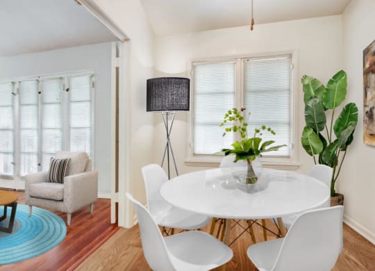 a dining room with a round table and white chairs  at 1022 Tiverton, Los Angeles, CA, 90024