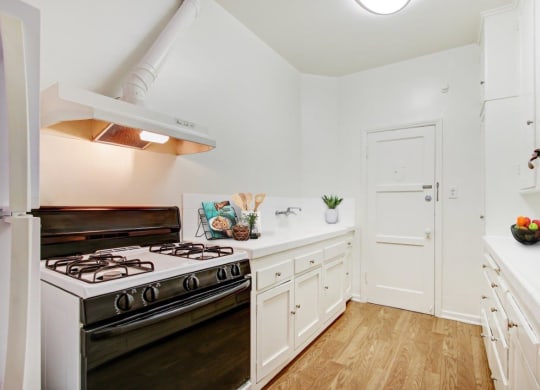 a kitchen with a stove top oven next to a doorway at 1022 Tiverton, Los Angeles, California