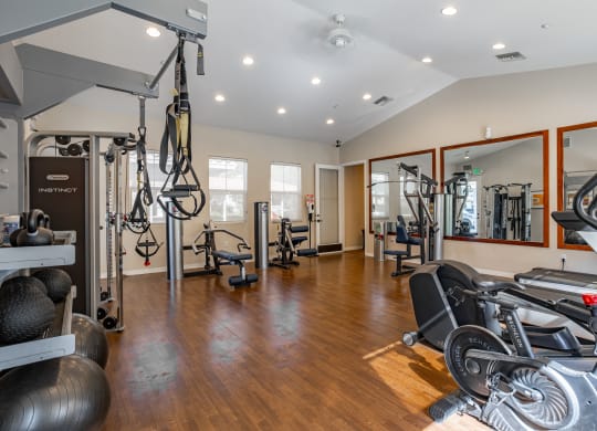 a home gym with exercise equipment and mirrors at Canyon Crest, Riverside, CA
