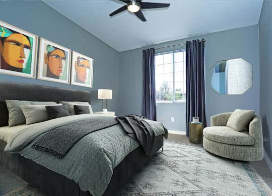 A bedroom with a bed, chair, and artwork on the wall.