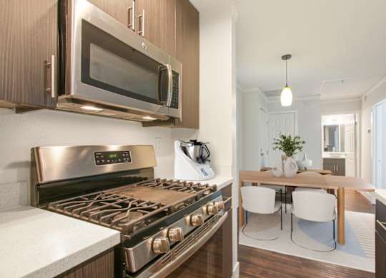 A modern kitchen with a stainless steel oven and microwave.
