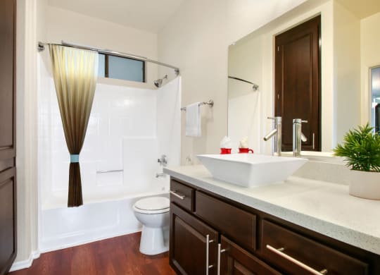 a bathroom with a sink and a toilet and a shower at Darlington Apartments, Los Angeles, CA