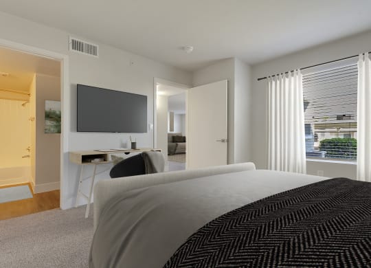 a bedroom with a bed and a desk and a tv at Bella Terra Apartments, Henderson, NV