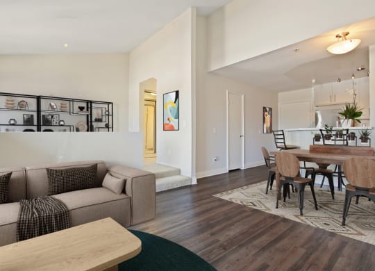 a living room and dining room with a table and a couch at Palm Royale Apartments, Los Angeles, CA