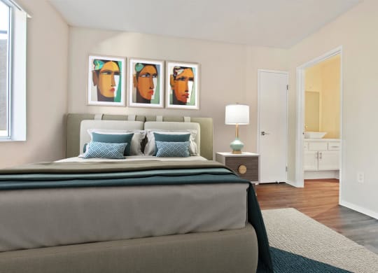 a bedroom with a bed and paintings on the wall at Palm Royale Apartments, Los Angeles, CA