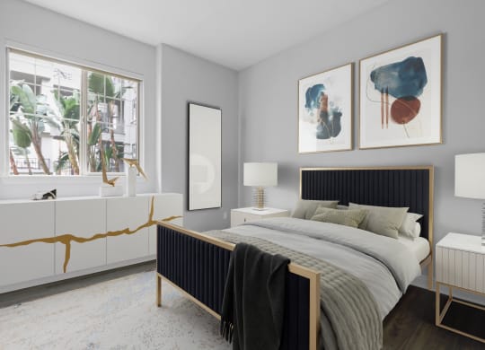 a bedroom with a bed and two paintings on the wall at The Adler Apartments, Los Angeles, CA