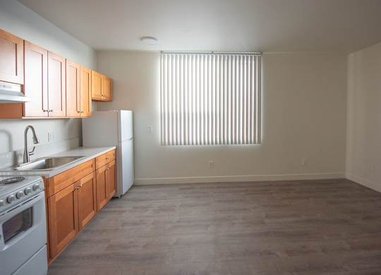 A kitchen with wooden cabinets and a white refrigerator.