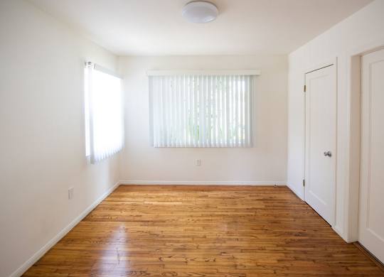 A room with wooden floors and white walls.
