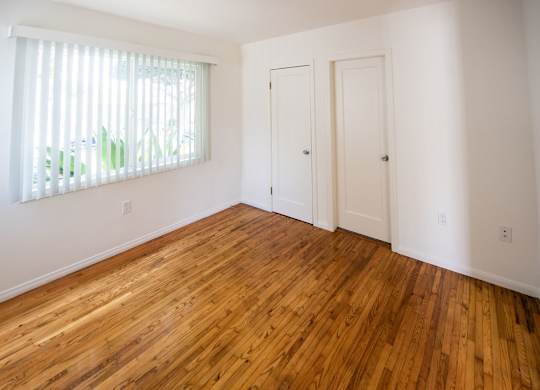 A room with wooden floors and white walls.