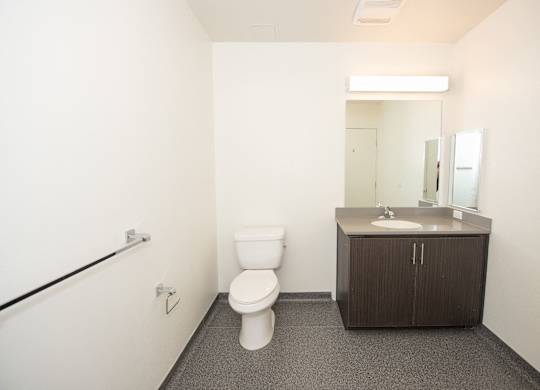 Sample Unit: Bathroom with toilet, sink, and mirror