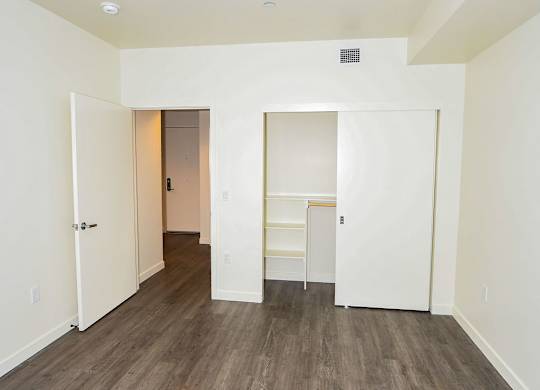 A room with a wooden floor and white walls.