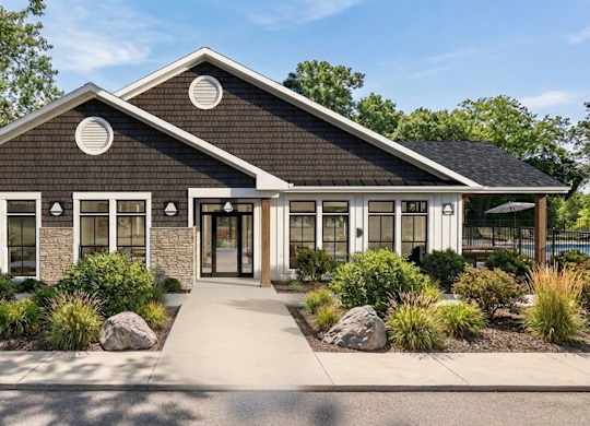 A modern house with a black roof and white trim.