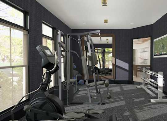 A gym with a variety of equipment including treadmills, weights, and exercise machines.
