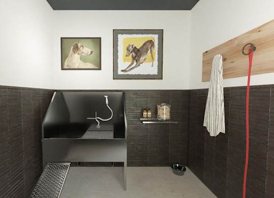 A bathroom with a black tiled wall and a white towel hanging on a hook.