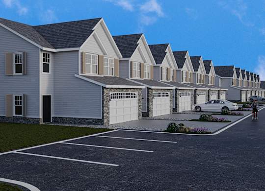 A row of houses with a person riding a bike in front.