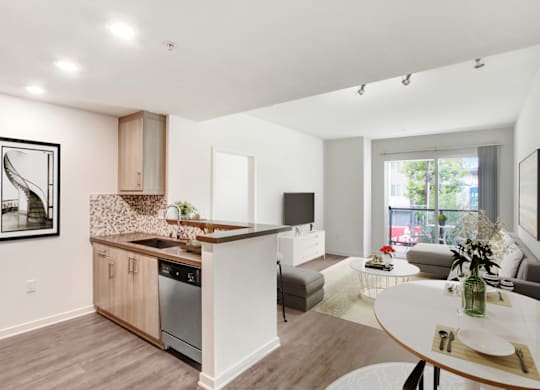 A modern kitchen with a dining table and chairs.at Vues on Gordon, California, 90028