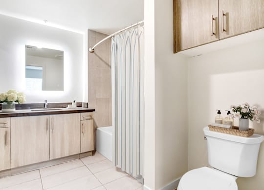 A modern bathroom with a white toilet and a white sink.at Vues on Gordon, Los Angeles California 