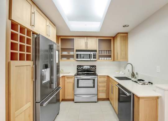 A kitchen with a refrigerator, oven, and microwave.at Wilshire Margot, Los Angeles California 