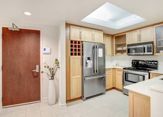 A kitchen with a refrigerator, oven, and microwave.at Wilshire Margot, California 