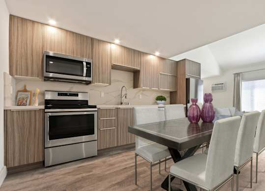 Kitchen with stainless steel appliances, wood kitchen cabinets, recessed lighting, wood style floors