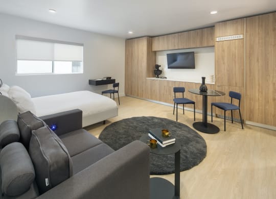 a living room with a couch and a table and a bed