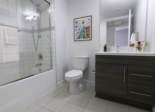 a bathroom with a shower and a toilet and a sink at Seventh West Apartments, Santa Monica California 