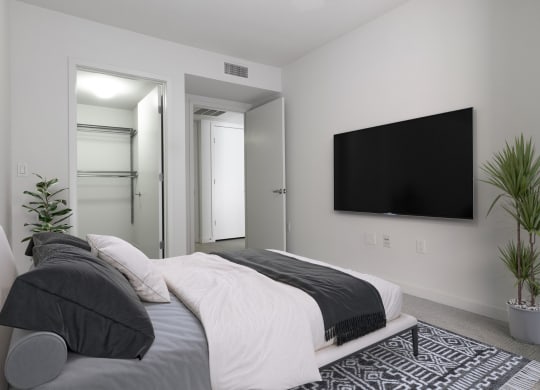 a bedroom with a bed and a tv on the wall at Seventh West Apartments, Santa Monica, 90401 