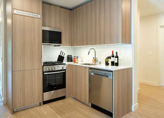 a kitchen with a stove and a sink at The Aster, Los Angeles, 90024