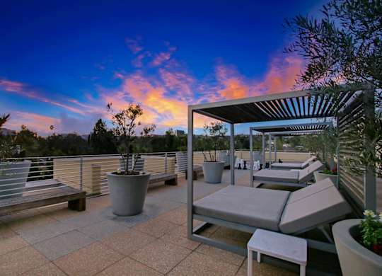 A patio with a table and chairs is set up on a terrace.at Wilshire Margot, Los Angeles California