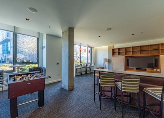 a living room with a bar and a foosball table