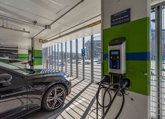 a car plugged into a charging station at a gas station