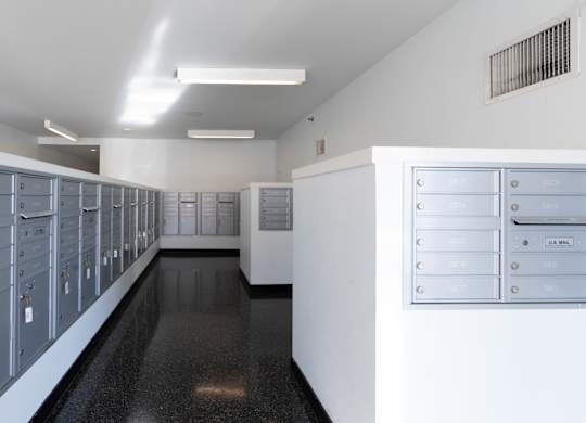 an empty locker room with a row of mailboxes