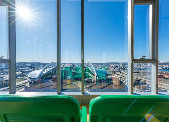 a view of a roller coaster from inside a bus with windows