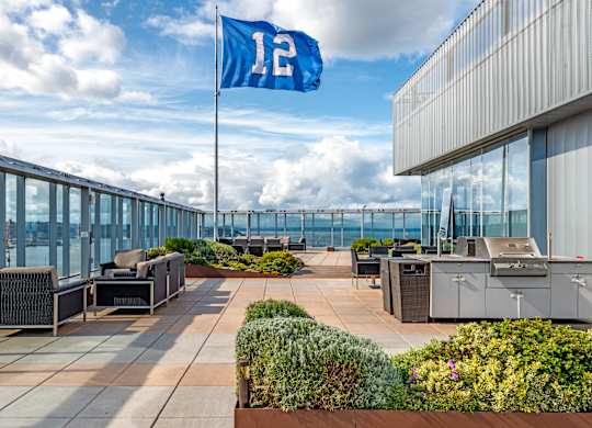 a rooftop patio with a flag and tables and chairs