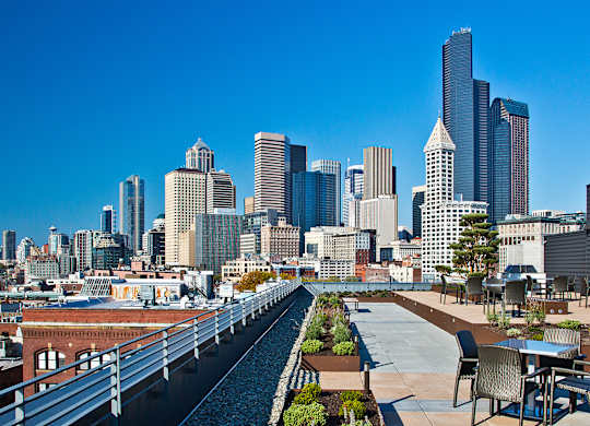 a rooftop terrace with a view of the city