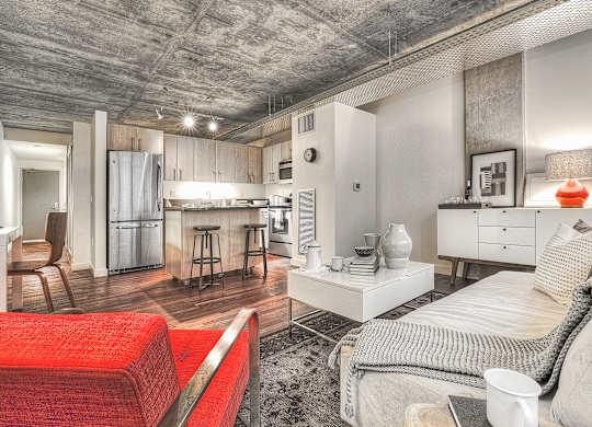 a living room with a couch and a kitchen in the background